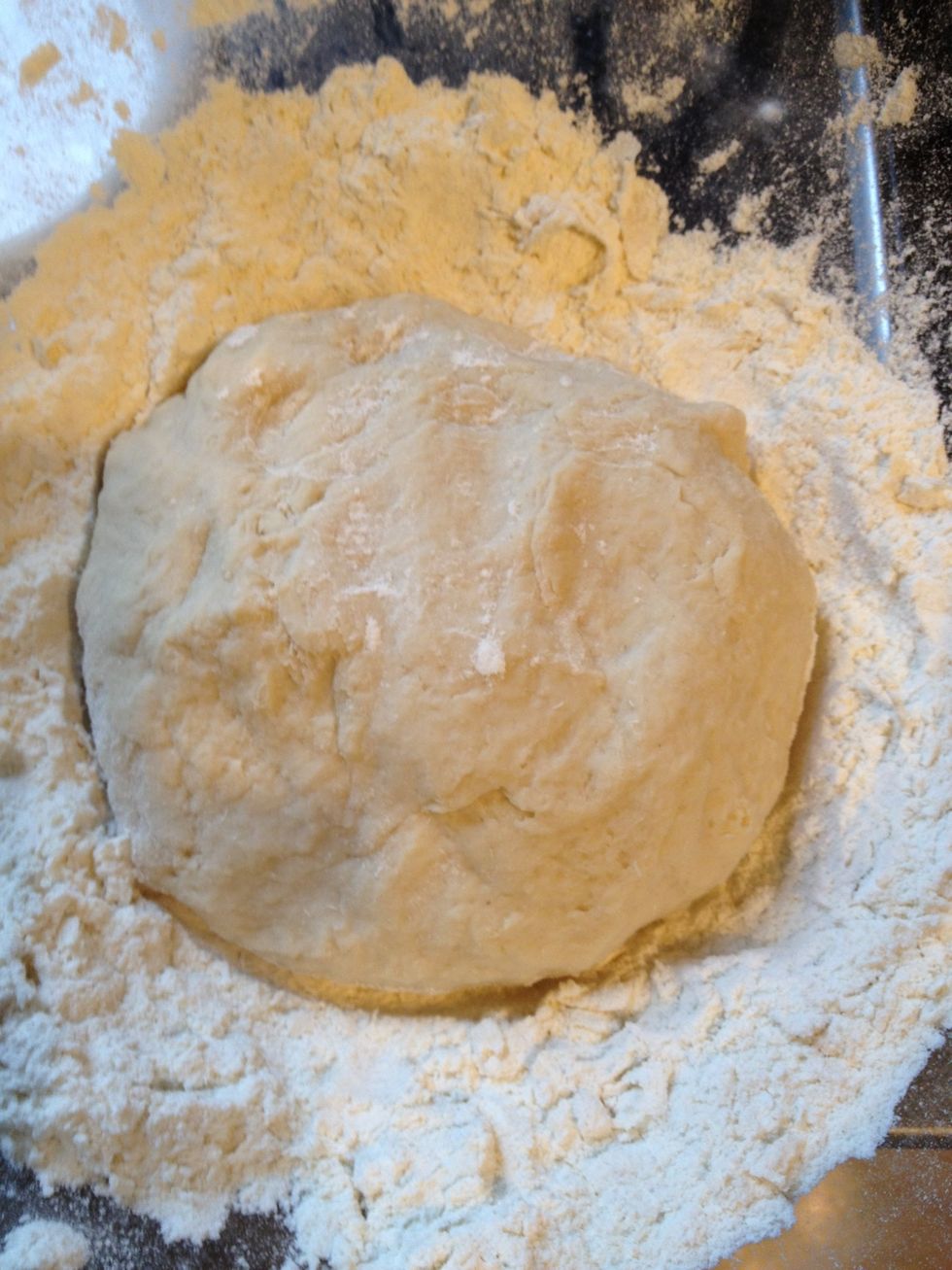 When the dough is getting more solid over time you can use your hands to form a nice ball. You don't have to work in all flour now as there will be more liquid added later.