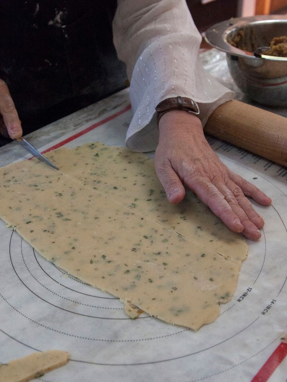 When the dough is rolled out, square it off, and cut it into wide strips.