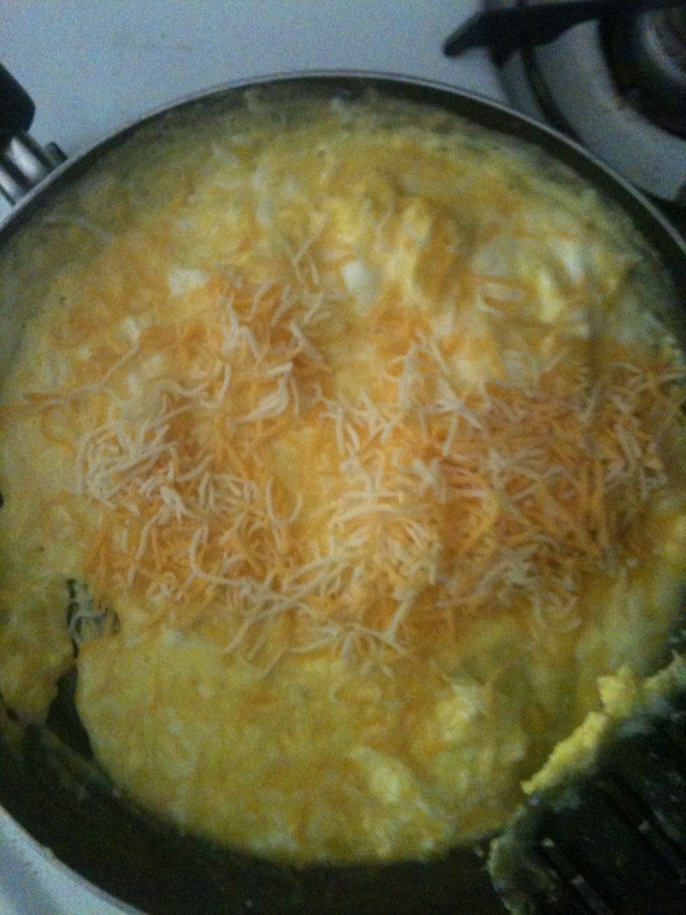 When the eggs are almost done cooking add cheese and salt if you want to.