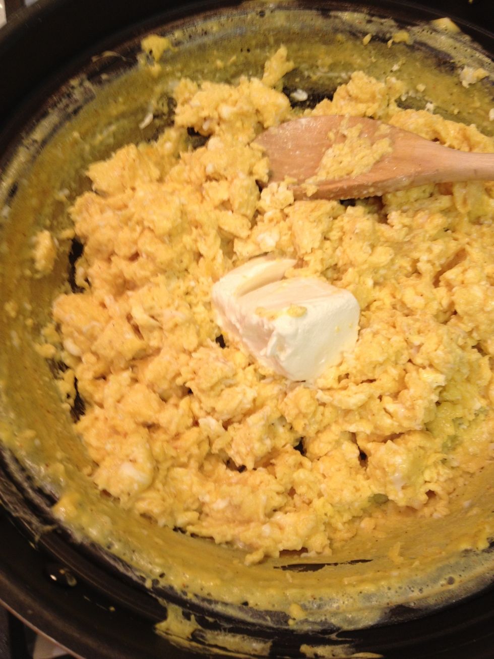 When the eggs are almost done, throw in some cream cheese.