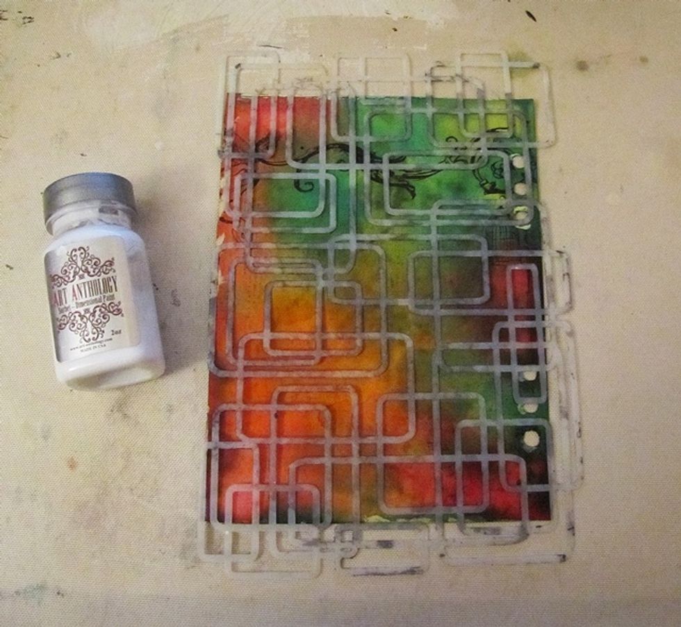 When the first page is dry, apply some Splashed through the stencil.