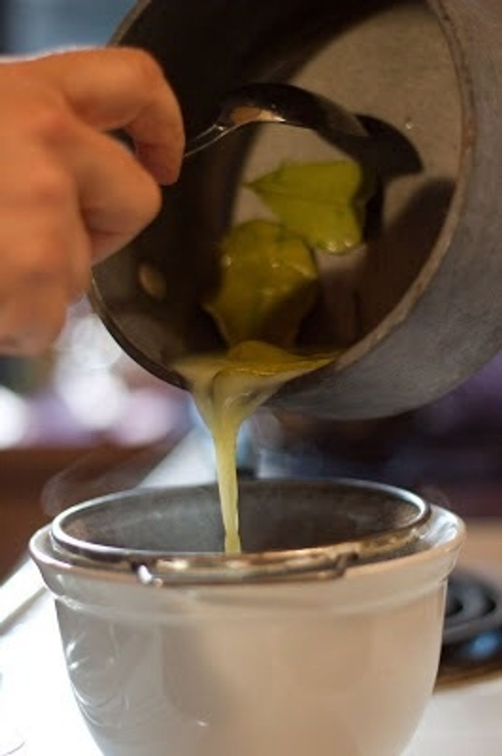 When the gelatine mixture starts to get soft, heat the cream mixture again and pour it through a mesh strainer into the gelatin lime water.