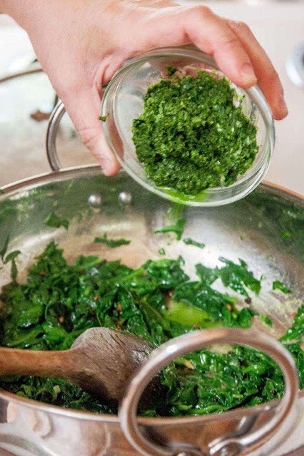 When the greens are wilted, and cooked through, remove the lid and add in the ground ginger paste. Add salt to taste and stir everything well. Let this blend cook for another 3 or 4 minutes.
