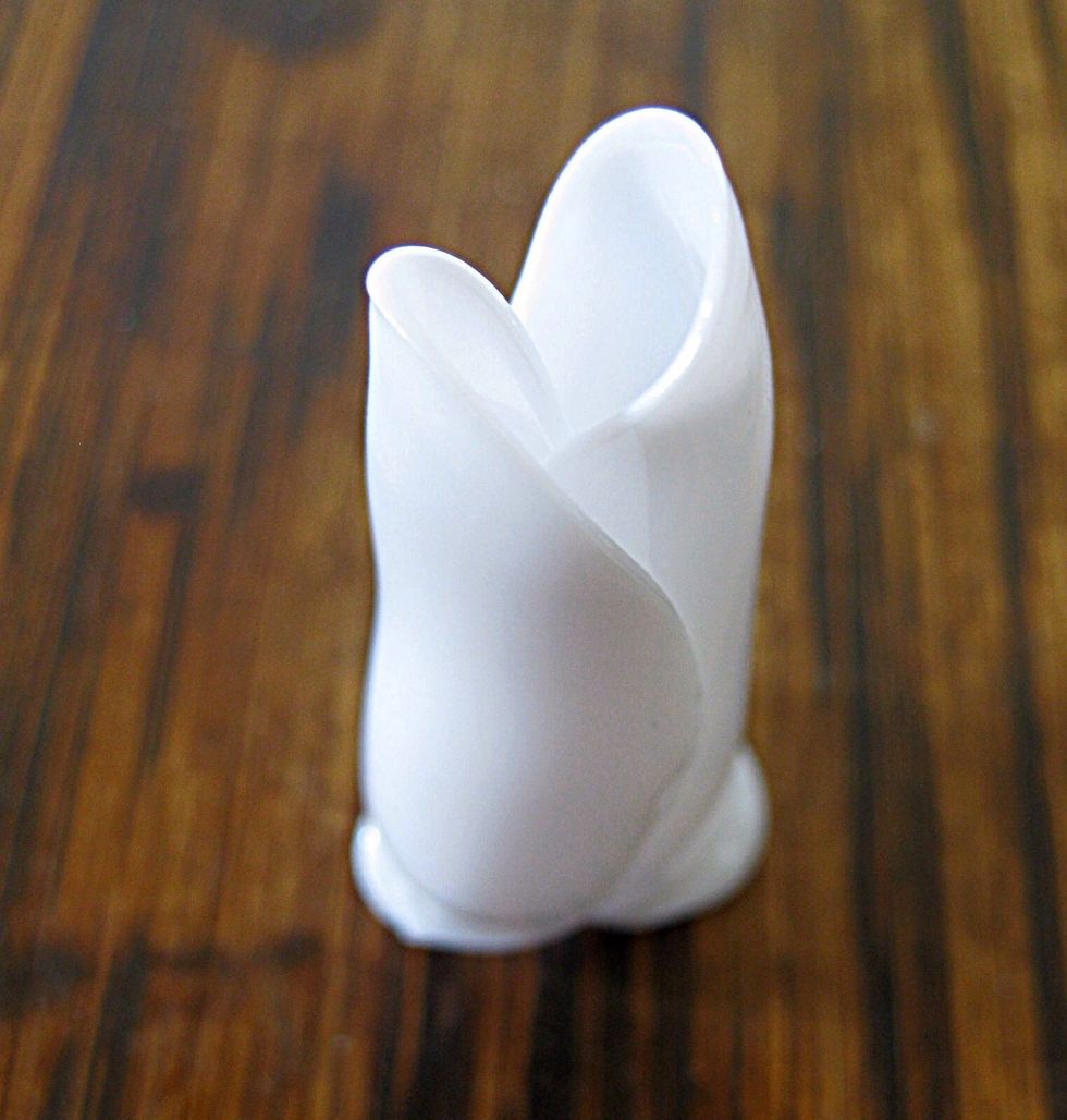 When the handles melt, pull them off of the rose bud and push the bud onto a ceramic tile to flatten the melted area.