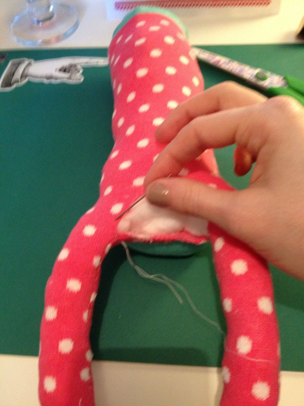 When the legs and body are stuffed, sew the bottom section up.