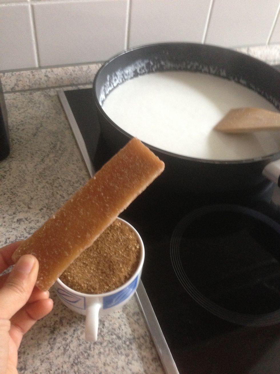 When the milk is boiling, add the sugar. You can Take either sticks or the normal Brown Sugar! Let is boil a few minutes until the Sugar  melt into the coconut milk! Always stir!