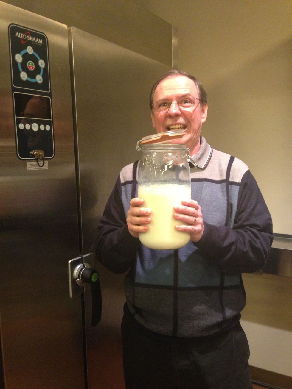 When the milk is cooled to 115F (46C),  You are ready to add the yogurt with live culture.