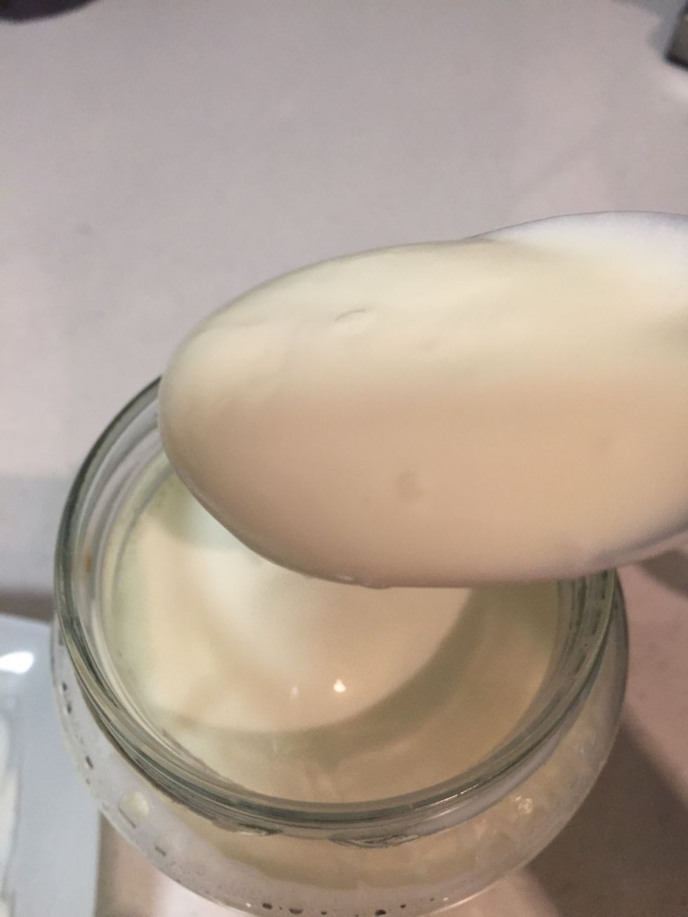 When the milk is ready, transfer it to your jar or lunchbox or any kind of bucket you want to keep the yoghurt then add the mixed yoghurt and milk into the jar. Mix it slowly for 5 seconds.