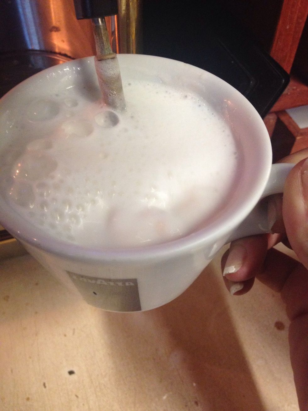 When the milk looks like it is boiling that means it should be done. Feel the side of the mug to make sure it's hot.