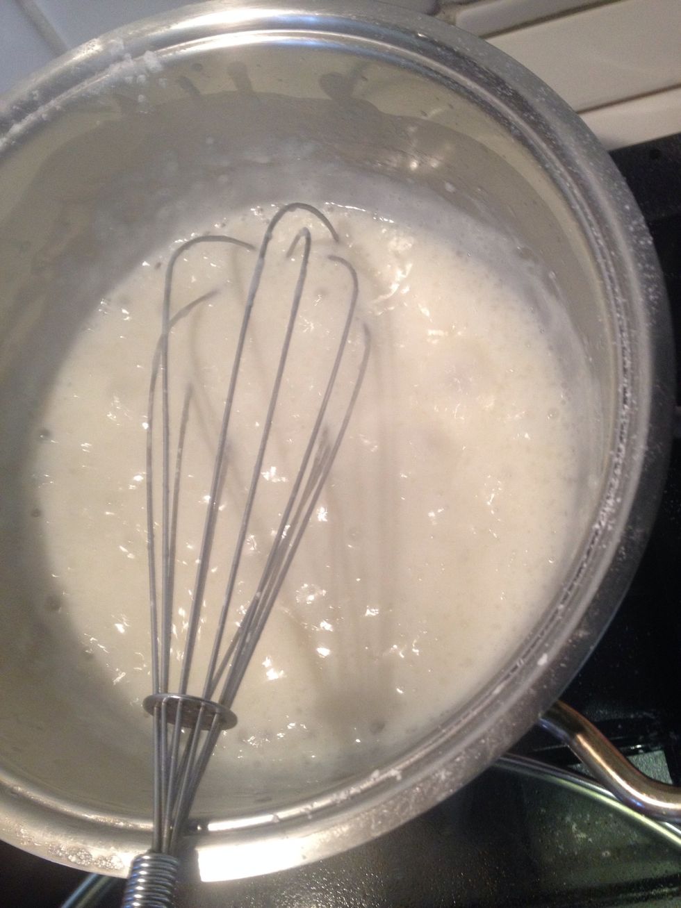 When the milk mixture boils add the mixture with the corn powder dissolved in and mix fast