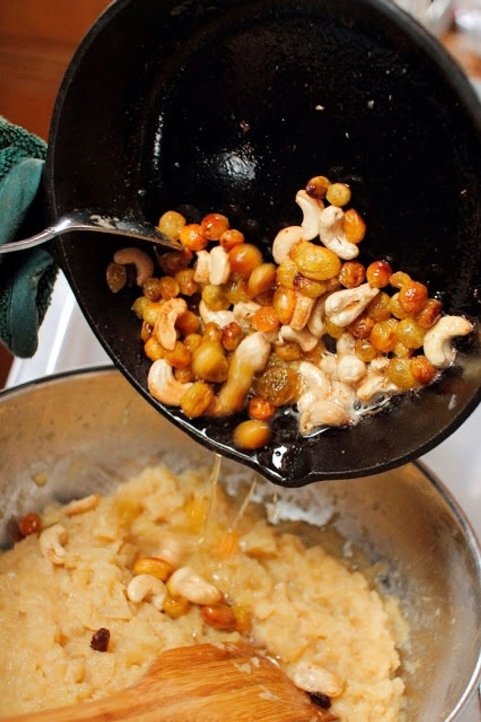 When the mixture is nice and thick and chunky add in the cashews and raisins. Stir in the cardamom and cinnamon.