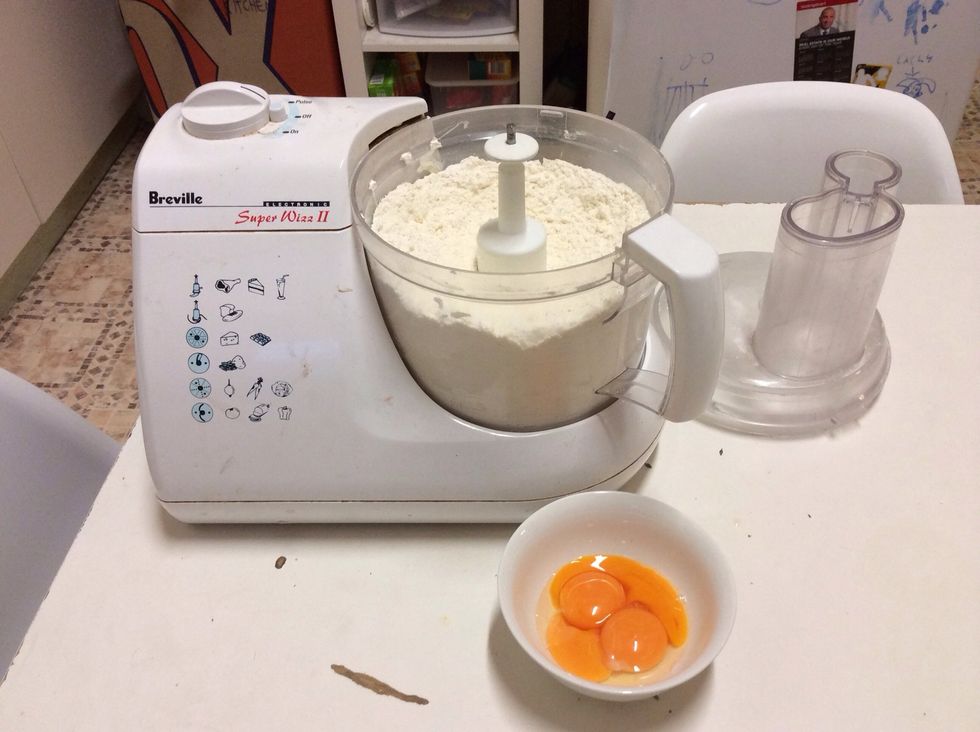 When the mixture resembles breadcrumbs add 3 egg yolks and process until it comes together in a dough ball.