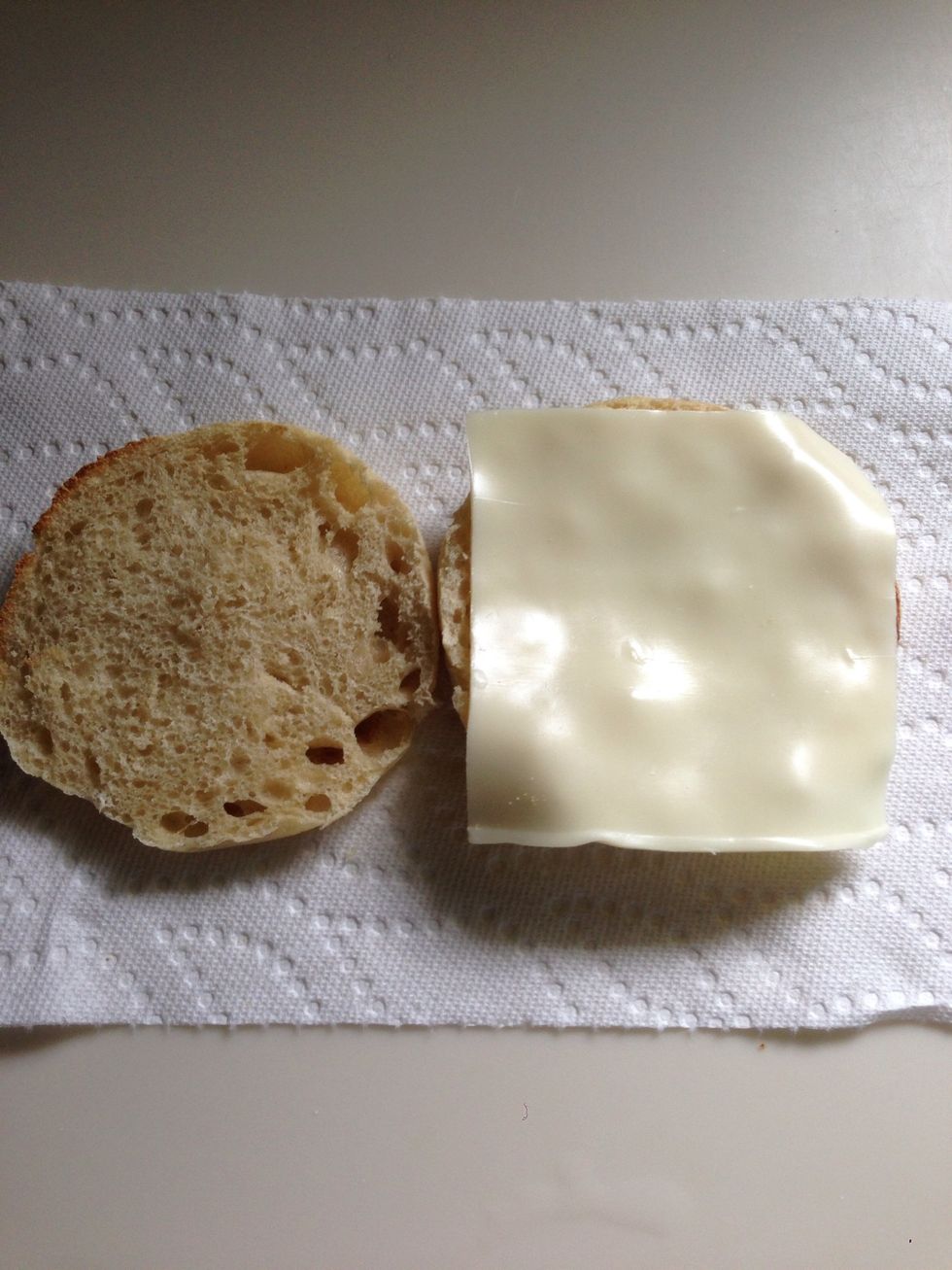 When the muffin is toasted, apply cheese.