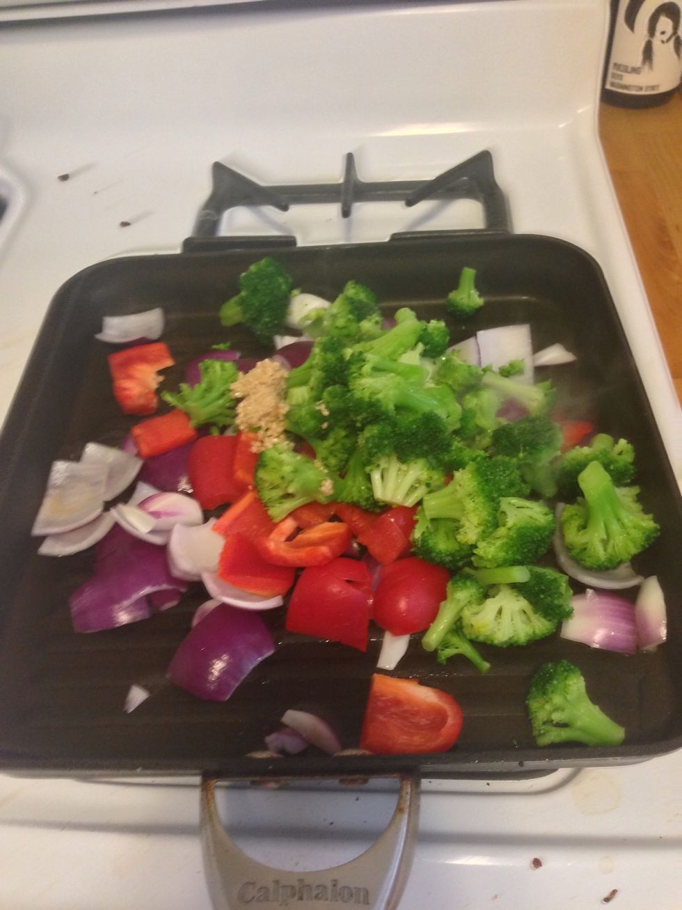 When the oil gets hot, add all of the vegetables in the pan. I also added 1 tbsp of minced garlic.