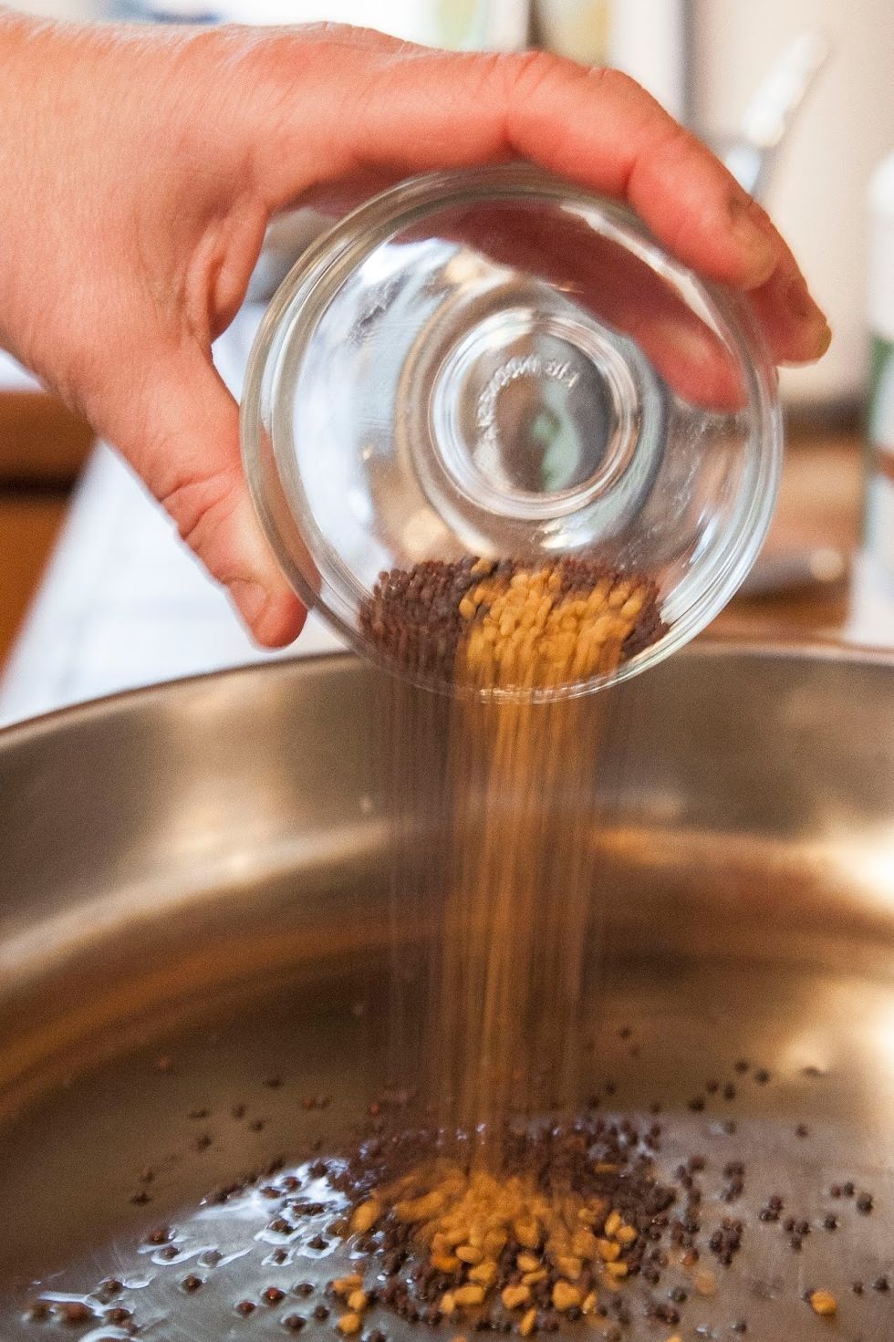 When the oil is ho,t toss in the fenugreek seeds and the mustard seeds.