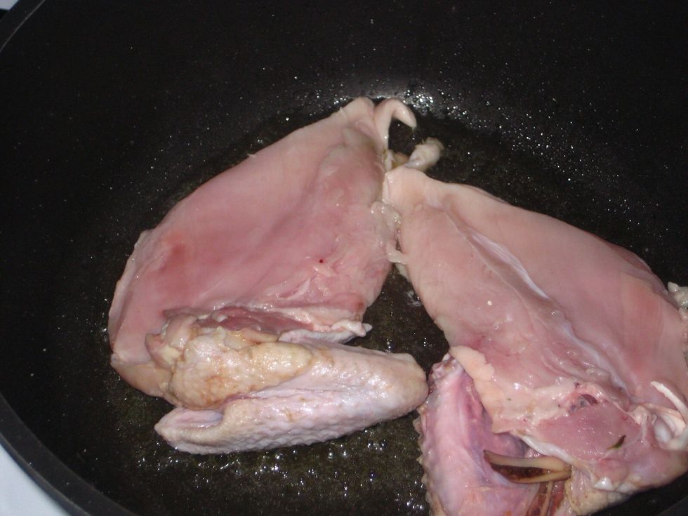 When the oil is hot, place the chicken breasts, skin down and allow to brown