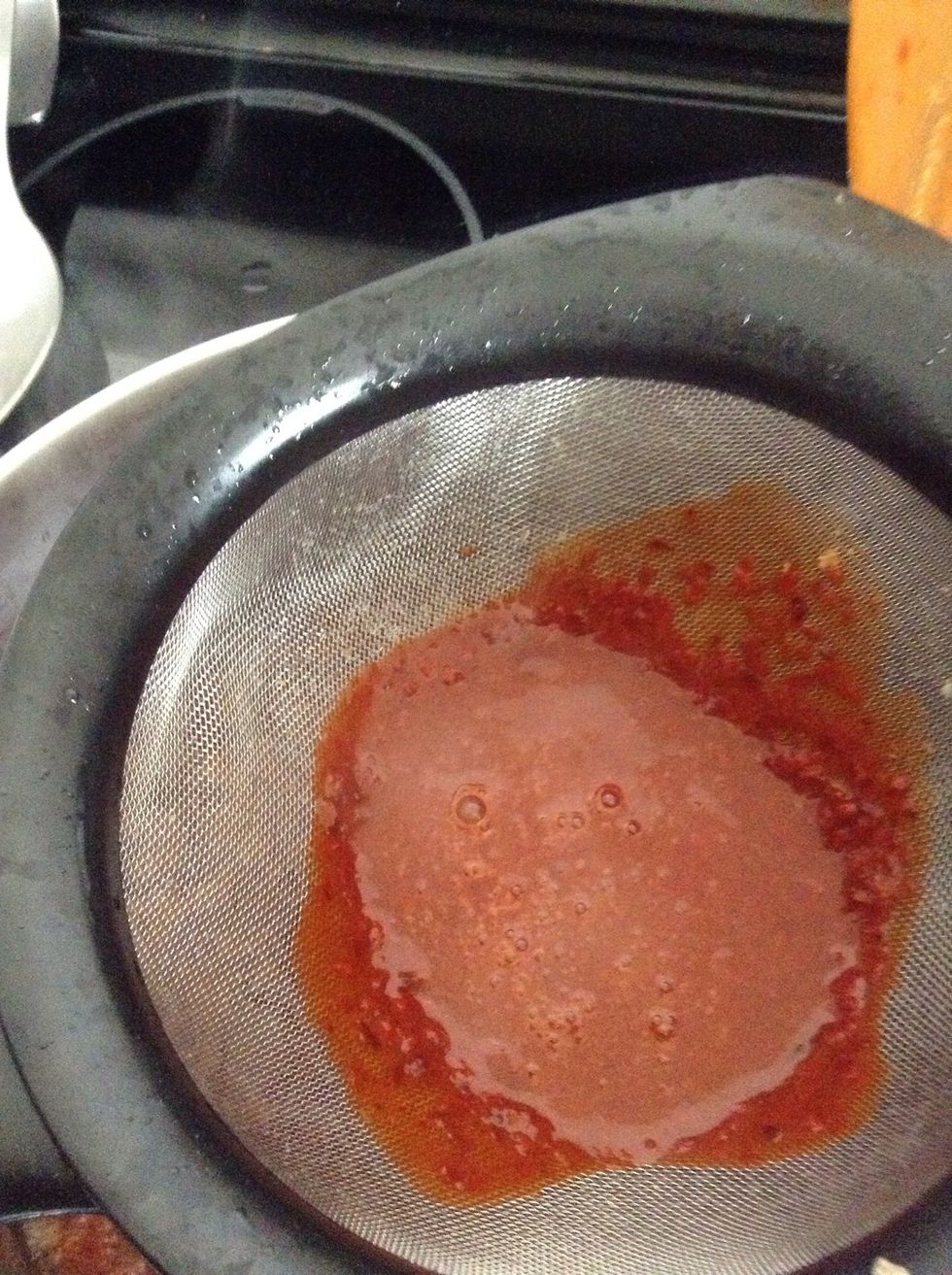 When the oil is warm, using a strainer, add the chile mixture to the pan.. Add more of the meat water that you had set aside with the chile mixture in the pan.