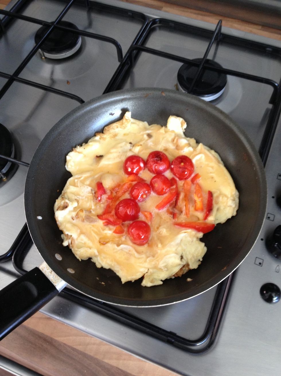 When the omelette has taken a rigid form remove from the heat. The mixture on top will still be runny.