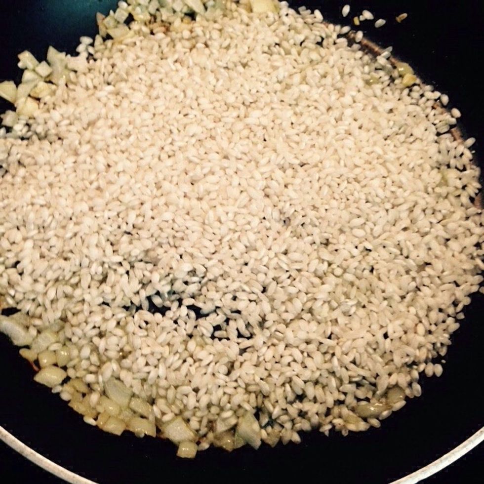 When the onion starts roasting add the dry rice to the pan. Saut\u00e9 until the rice is well toasted