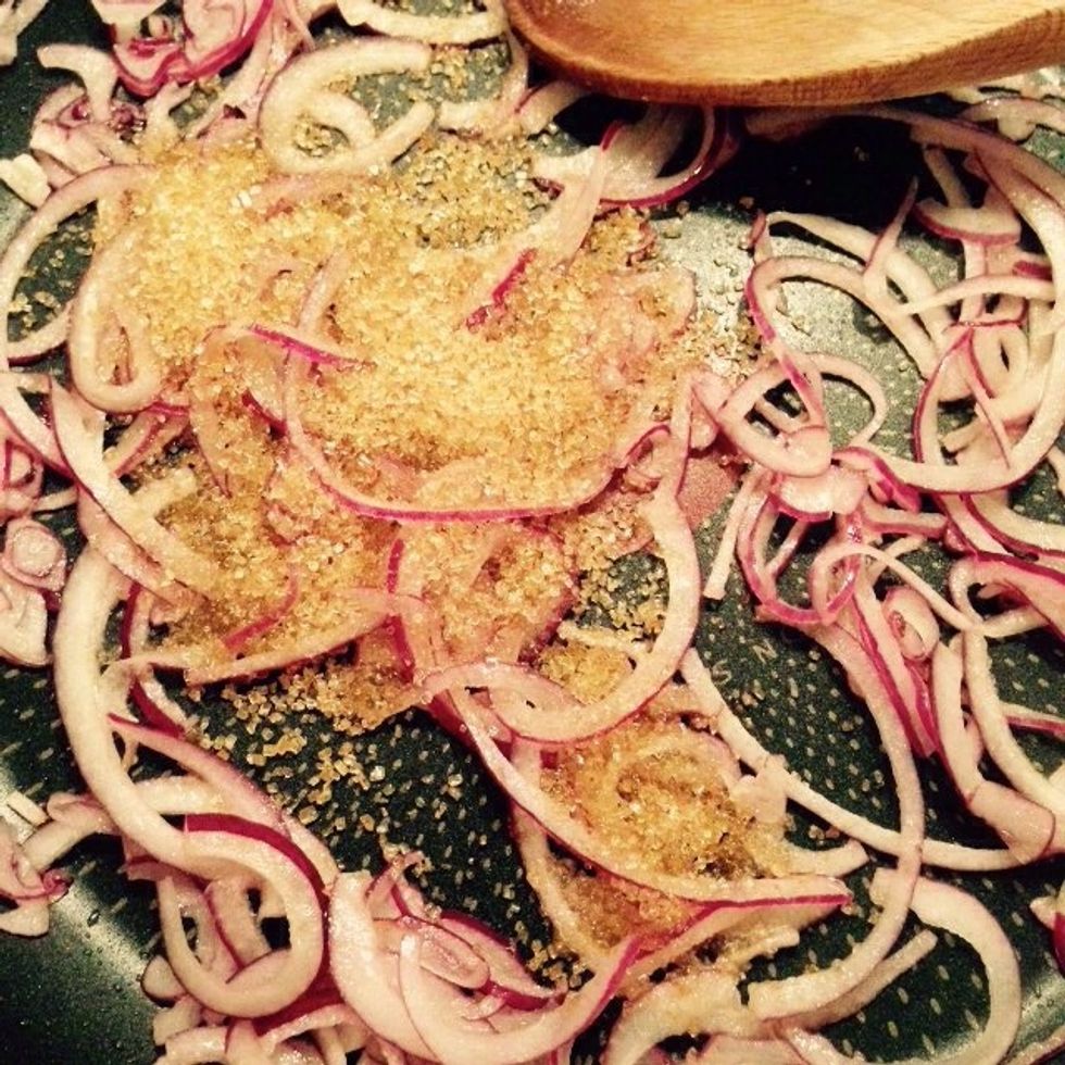 When the onion starts softening add the brown sugar to the pan