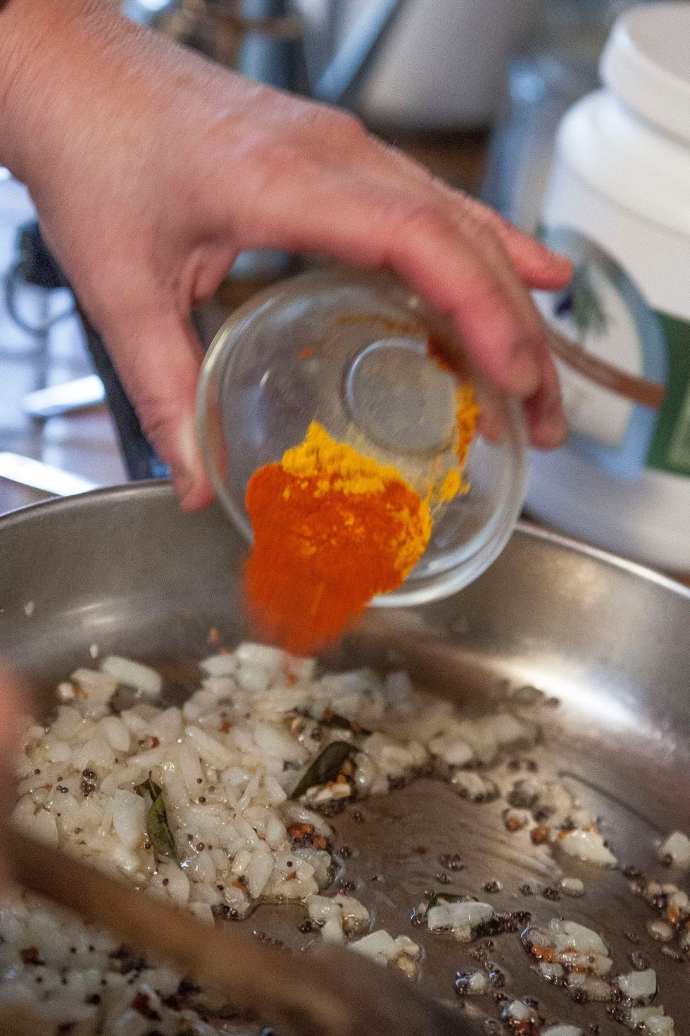 When the onion starts to turn a light golden brown add in the turmeric and Kashmiri chili.