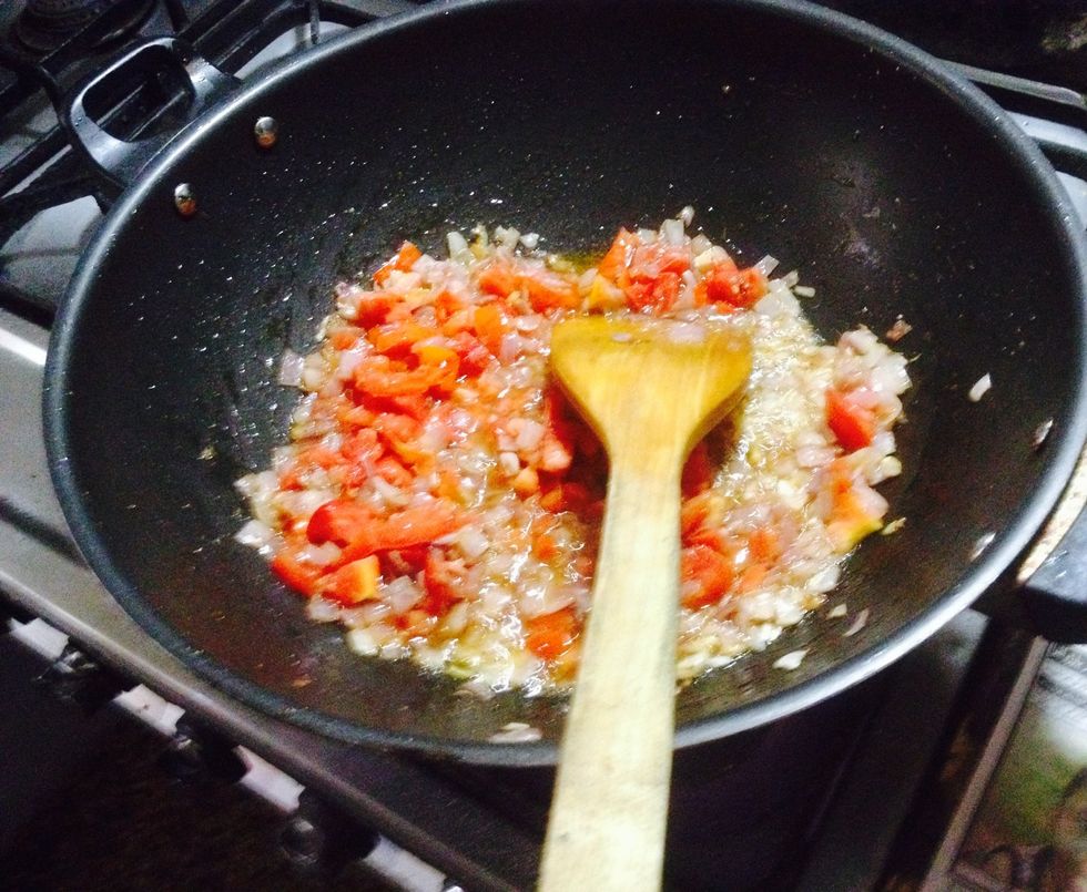 When the onions are golden brown Add tomatoes