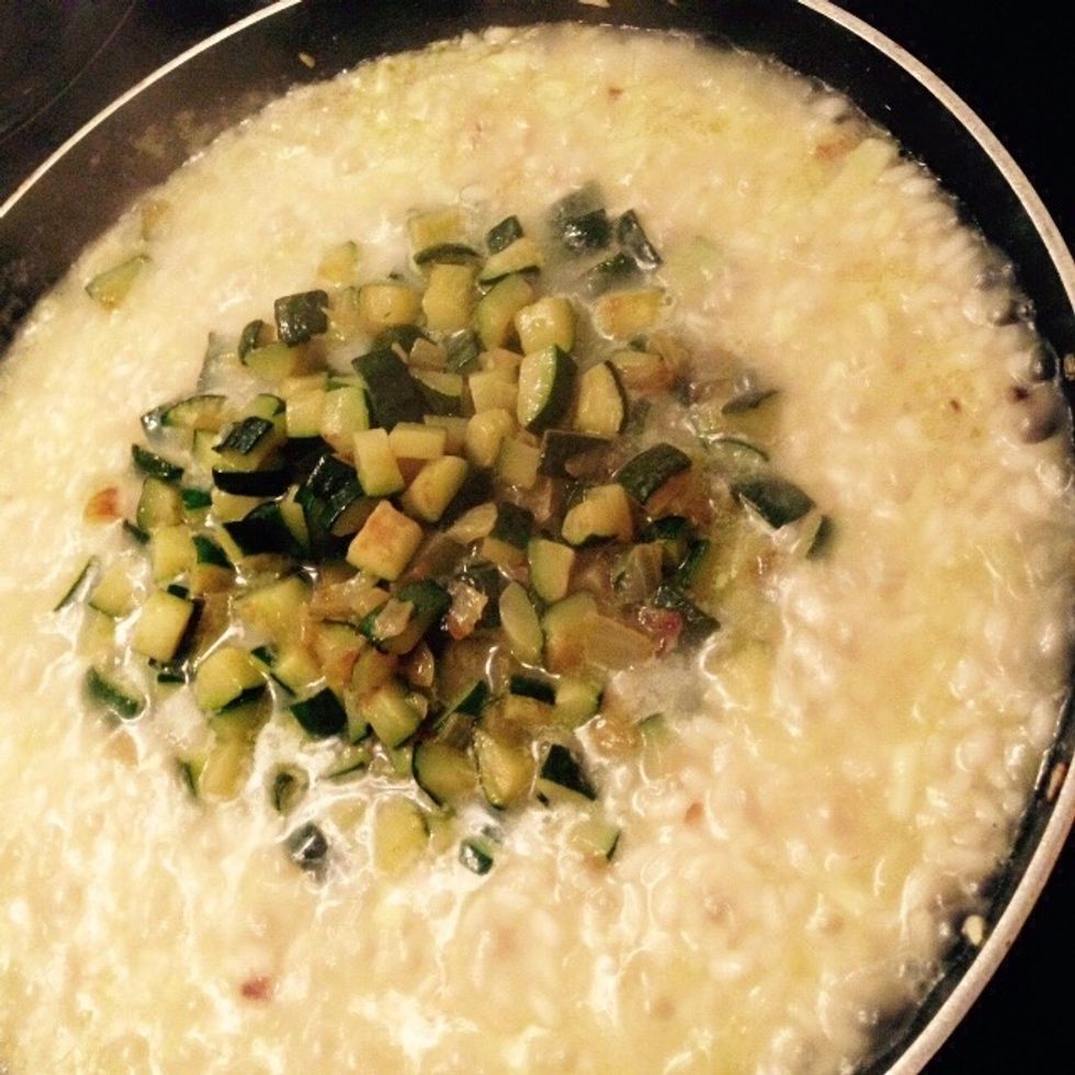 When the original stock is mostly evaporated add the courgettes to the pan
