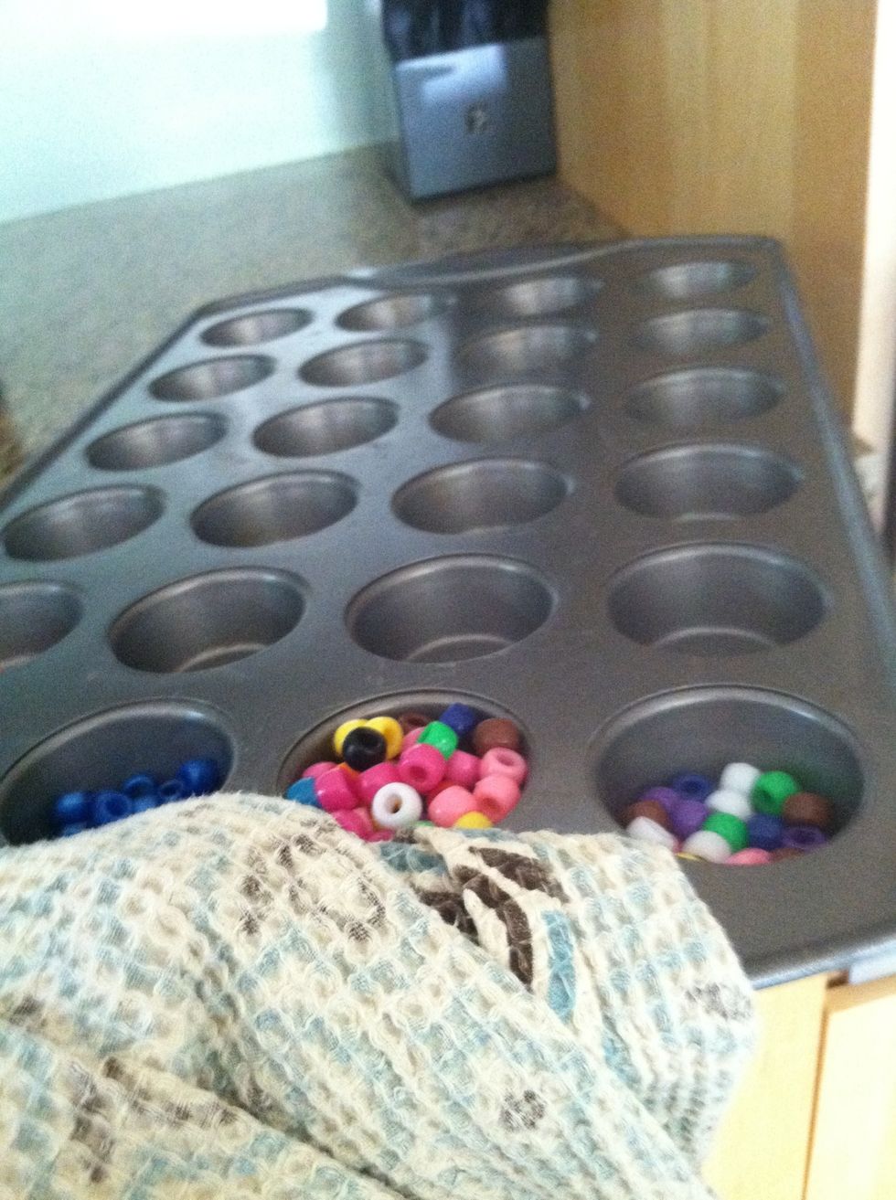 When the oven beeps, take your cupcake pan and put it in the oven with your oven glove/rag