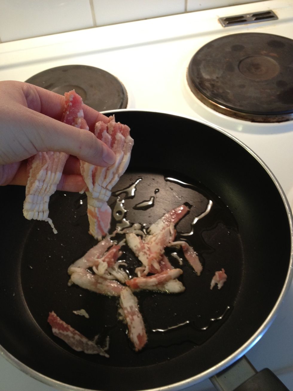 When the pan is hot, pour a tiny bit of olive oil and sprinkle the bacon and let it get golden brown.