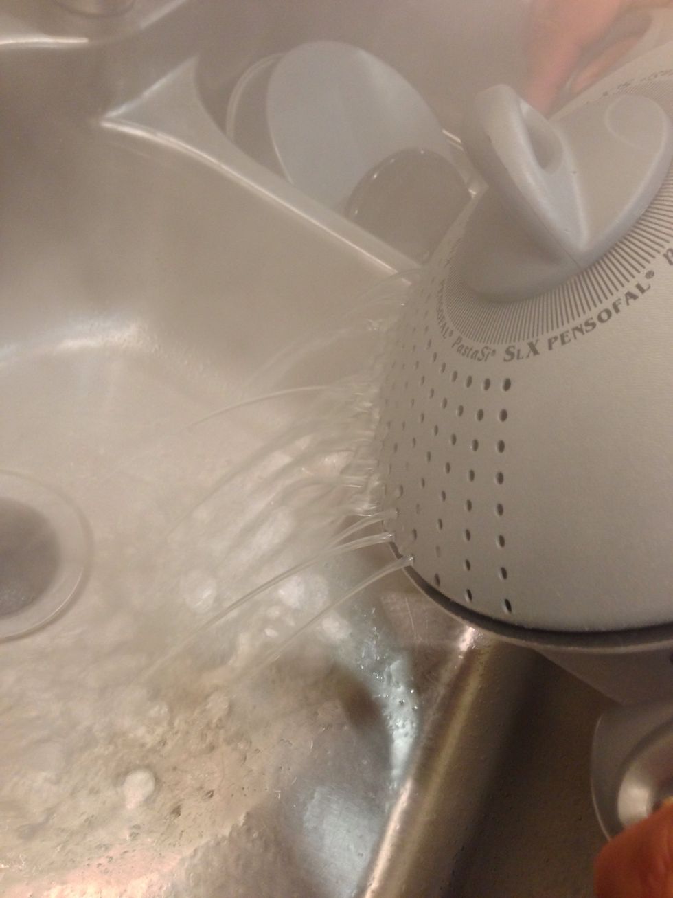 When the pasta is cooked to your liking, drain the water. My dad likes using this fancy locking lid, a colander will do just as well