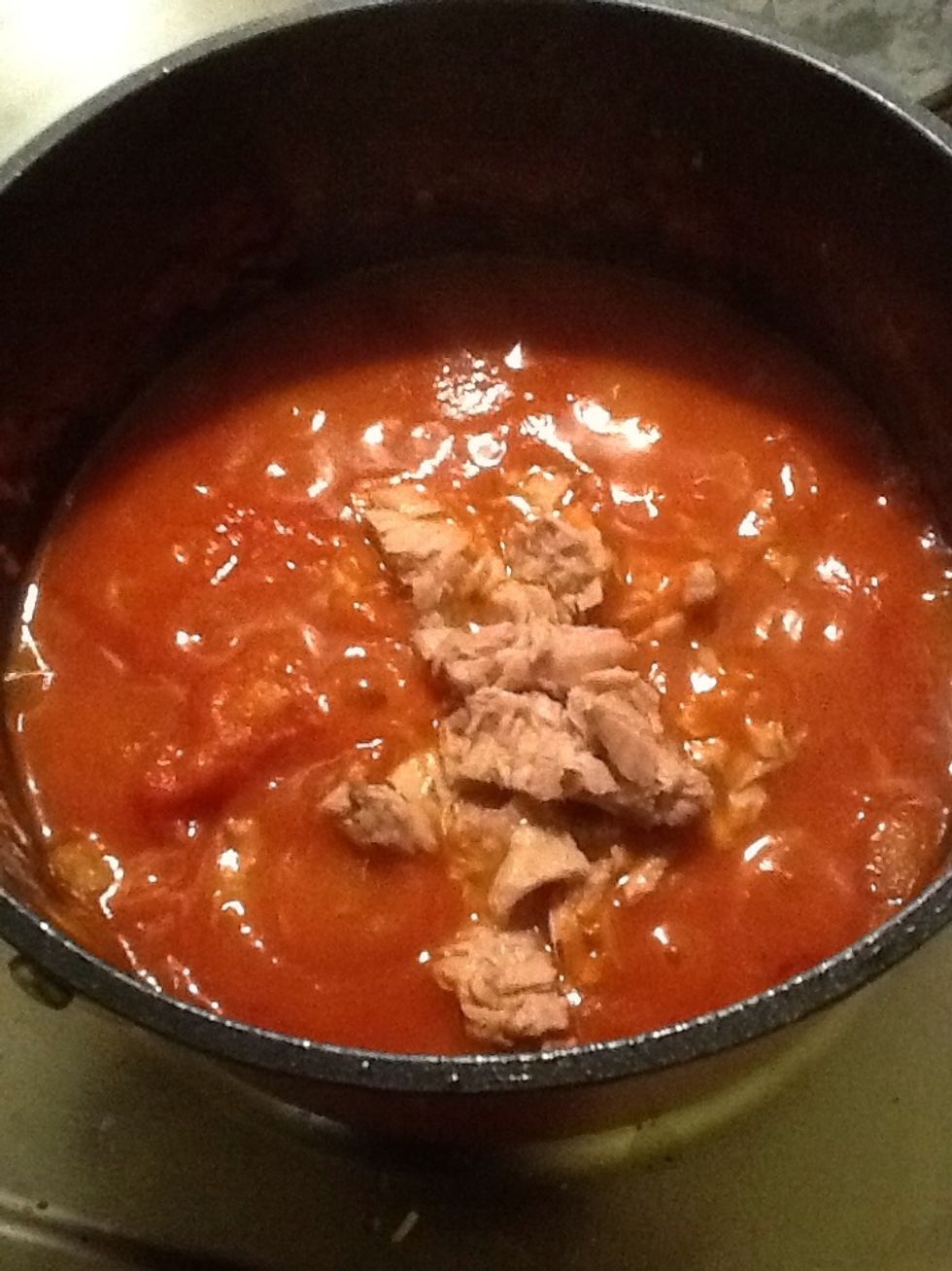 When the pasta is nearly cooked, stir some tuna into the sauce