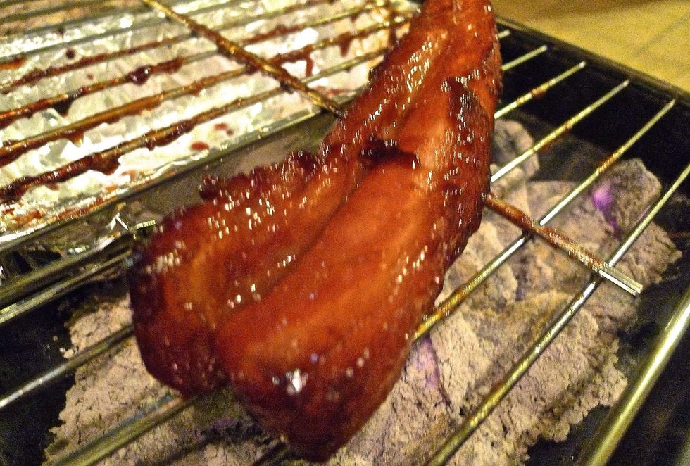 When the pork is about to cook, transfer it to the grilling grate on the other side for direct heat.