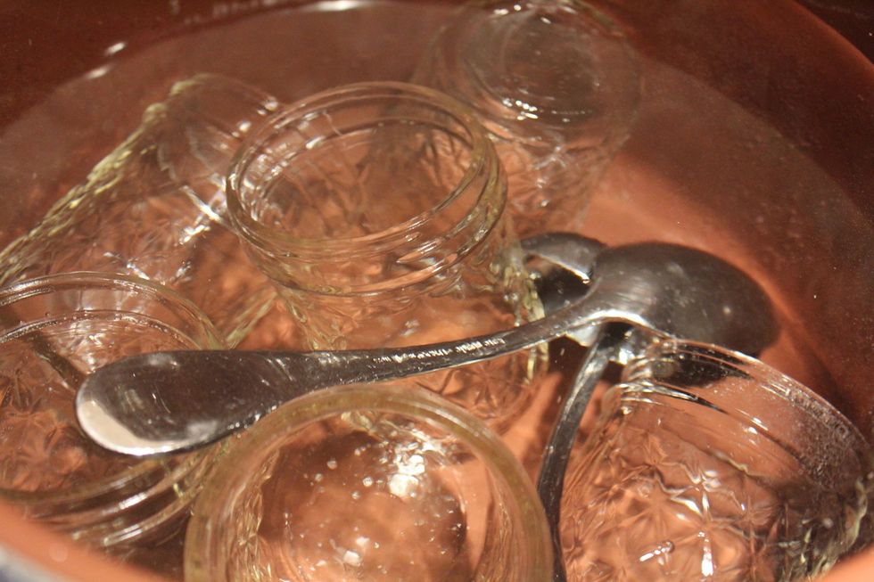 When the pot of plain water is at a boil, drop in jars & ladles & boil for 10 mins. Turn the pot off & toss in canning rings & lids, leaving them in the water until it's time to fill with marmalade.