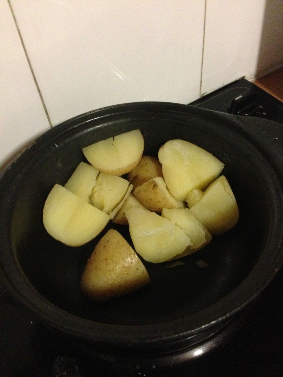 When the potato is cooked through, drain and allow to cool slightly.