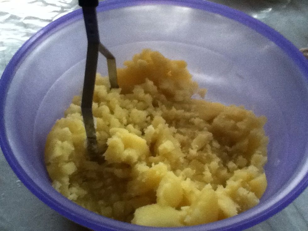 When the potatoes is soft, drain and mash them while hot