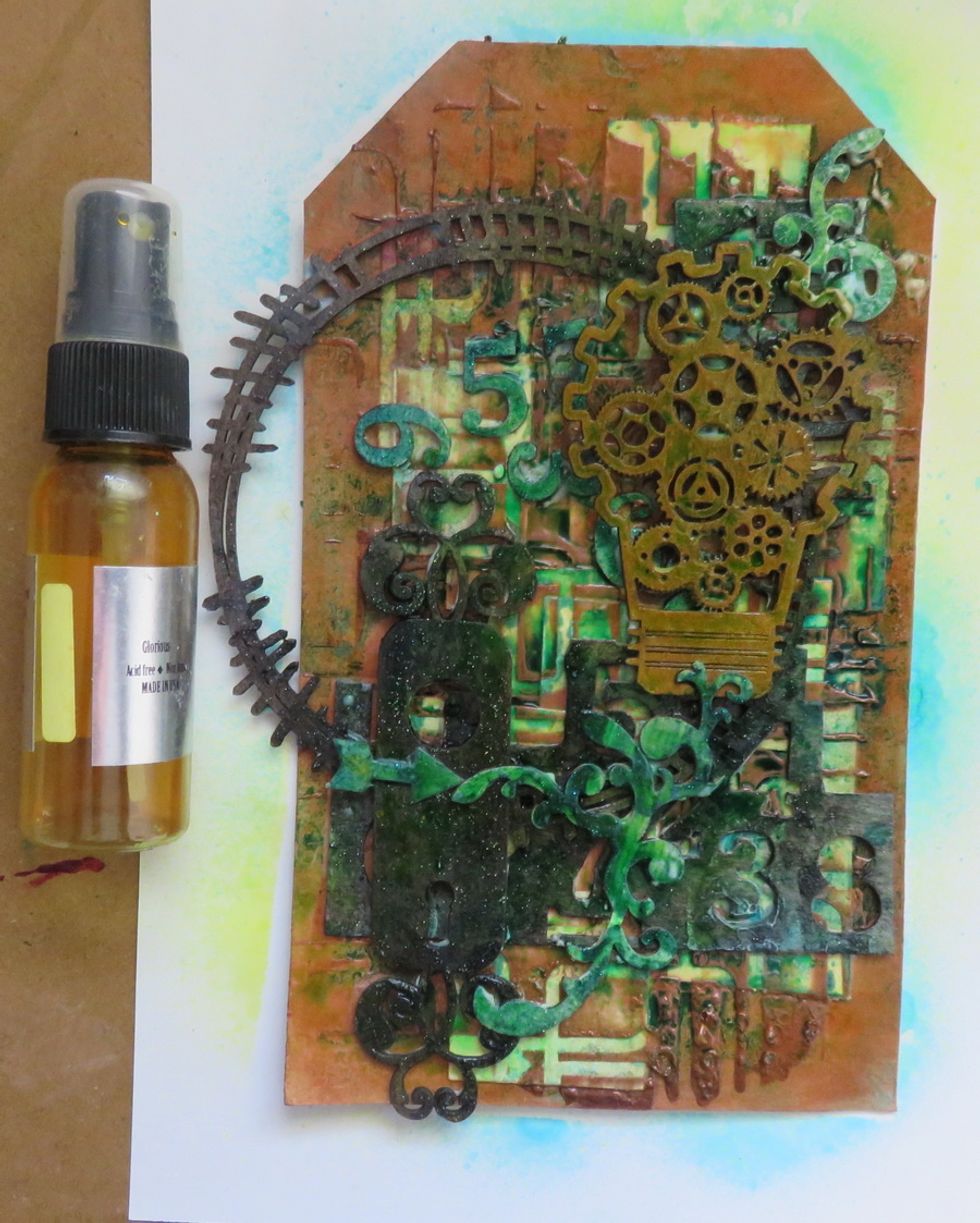 When the previous spray is dry add a layer of Glorious Colorations Spray over the tag.
