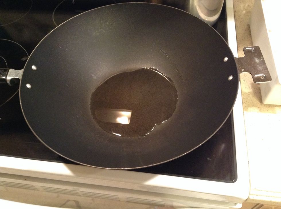 When the rice is ready, set it aside. Then, put enough canola oil into the wok to just cover the bottom. Next, heat on high heat