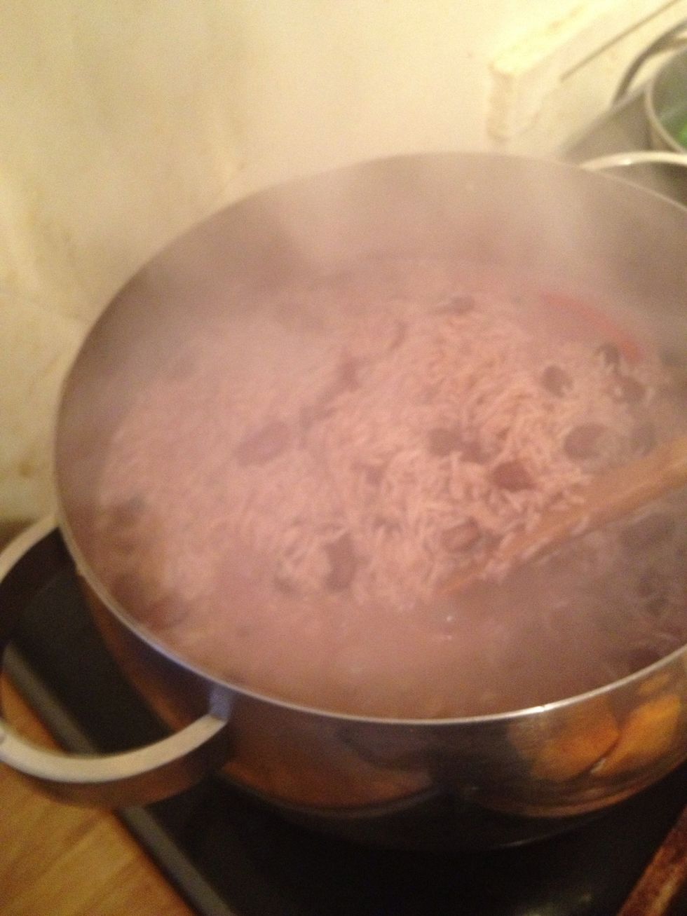 When the rice starts to show through the water it's time to reduce the heat