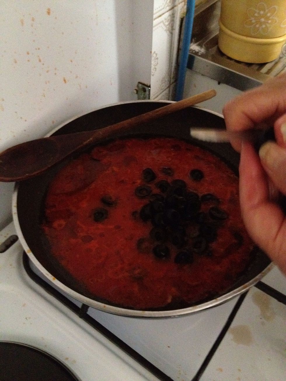 When the sauce has narrowed add the olives, cut them in half