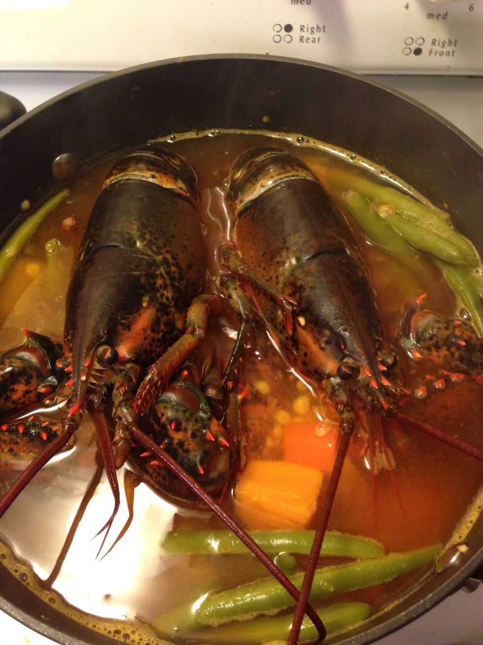 When the soup starts boiling up again drop the lobsters in and cover with lid! Start a 6 minute timer!