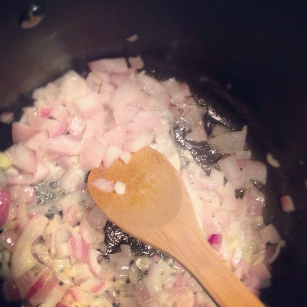 When the squash has cooked 40 minutes, combine the following in a large pot: 4 tablespoons melted butter; 1 onion; 2 cloves garlic