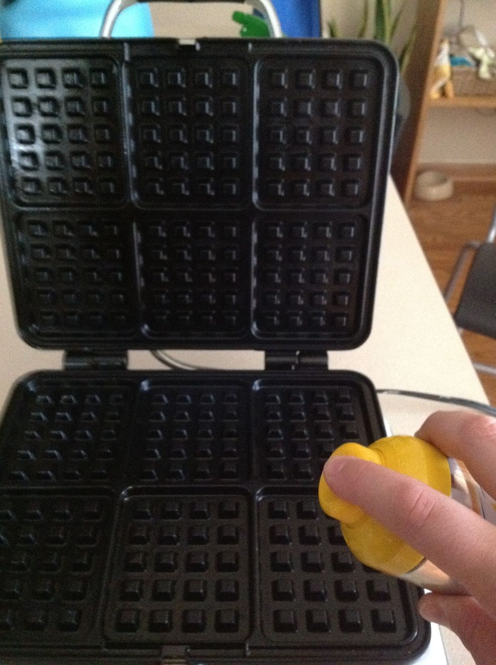 When the waffle maker is ready, spray the cooking area generously with the non-stick cooking spray.