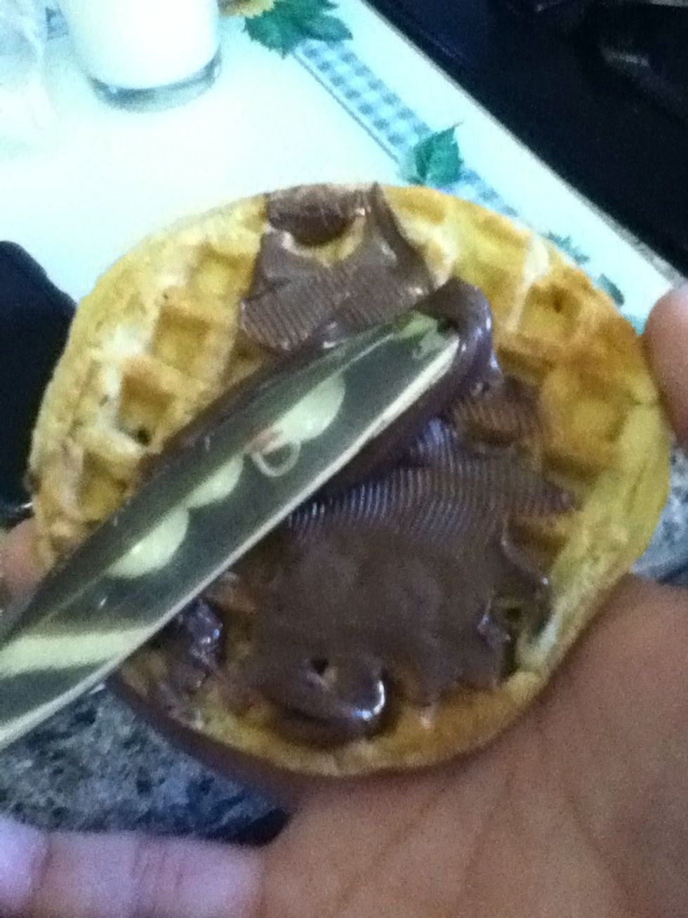 When the waffles come out spread your desired amount of nutella.