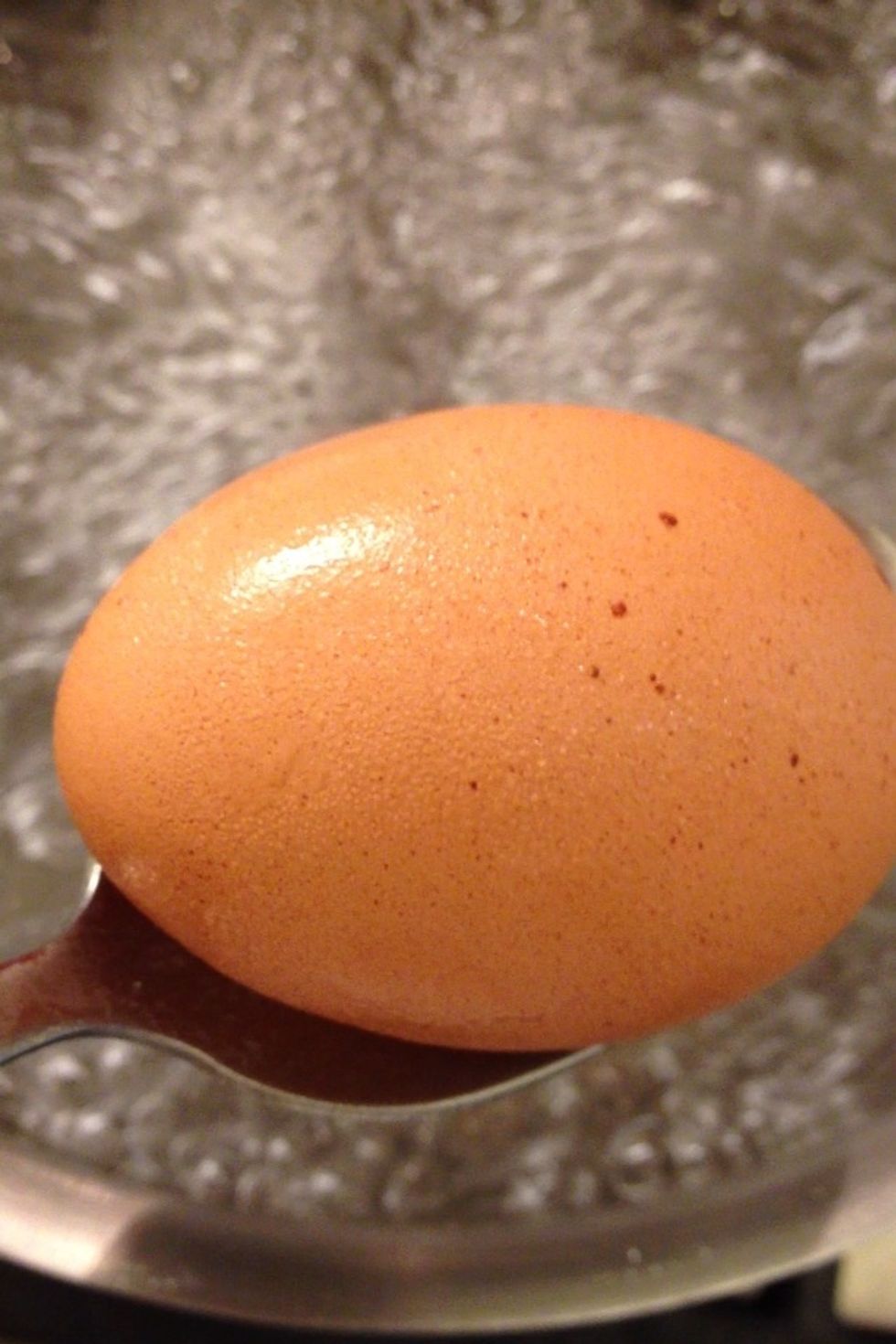 When the water boils drop the egg very gently so it doesn't crack.