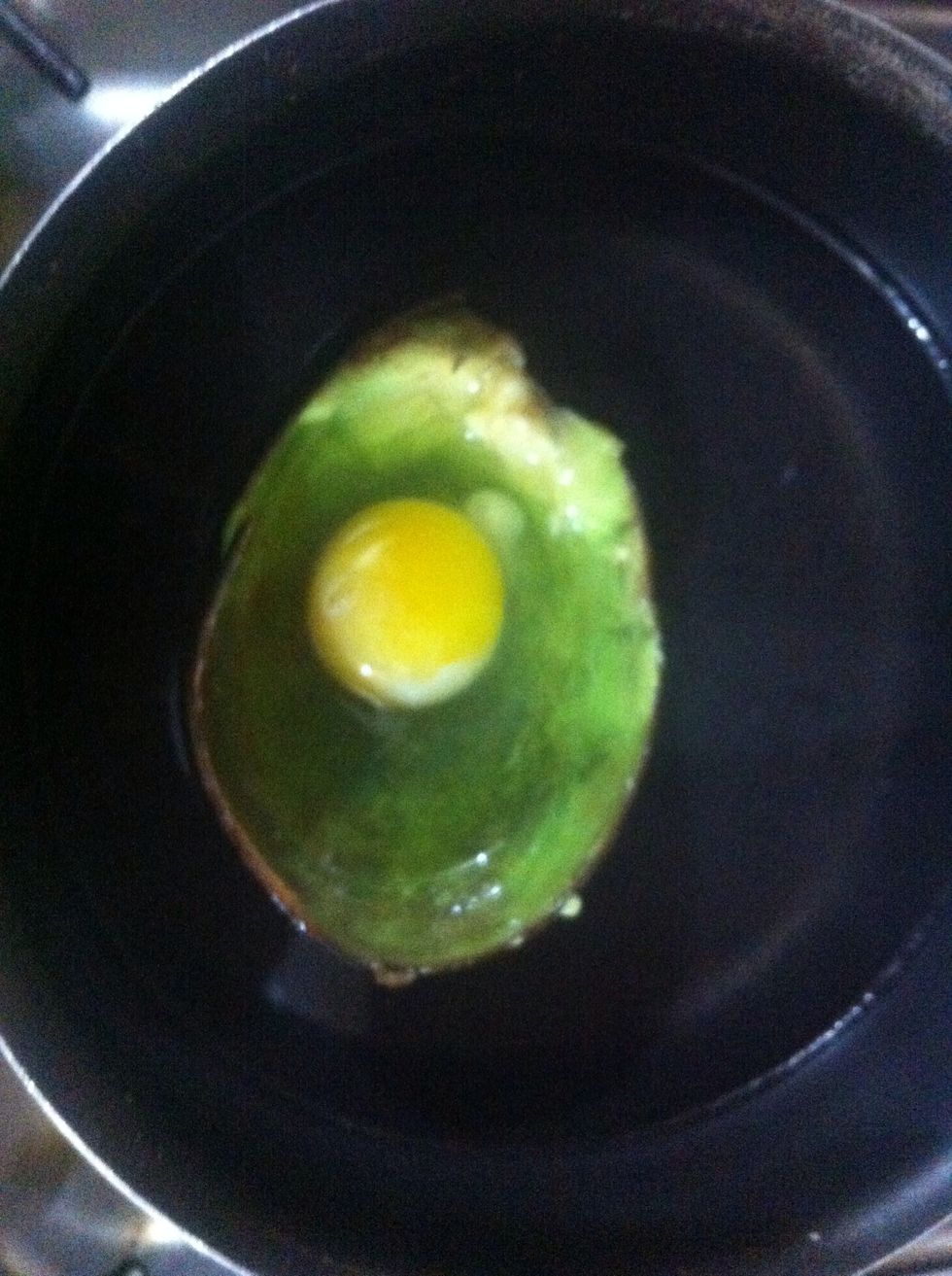 When the water boils, lower the flame n let it simmer. Place the avocado skin with egg inside. It should float n stay on top. You can also add parsley and any other add on if you like