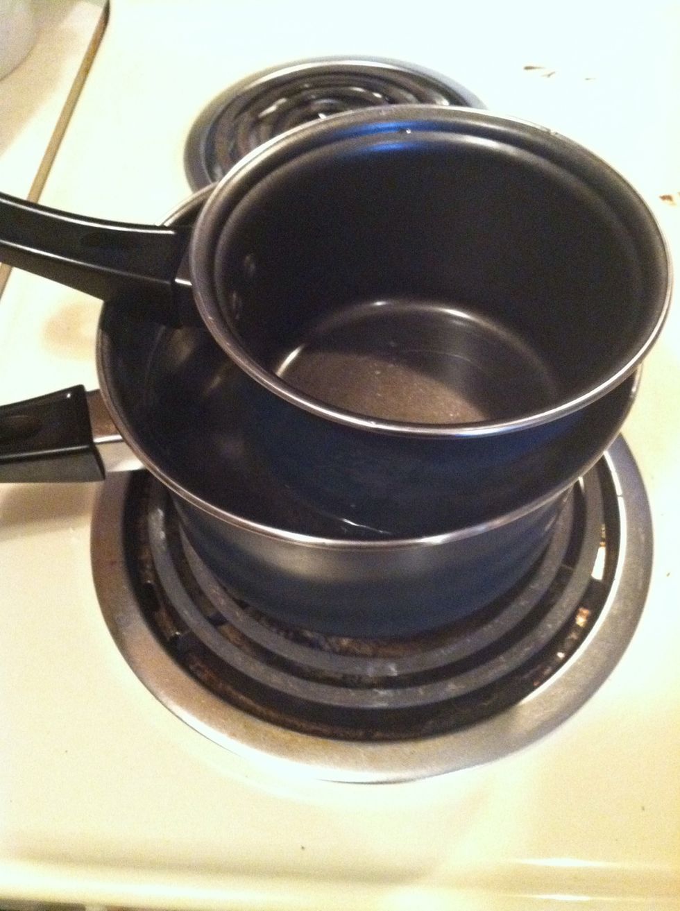 When the water gets close to boiling, place a small sauce pan inside it so the hot water is around the small pan. This is called a DIY double boiler!