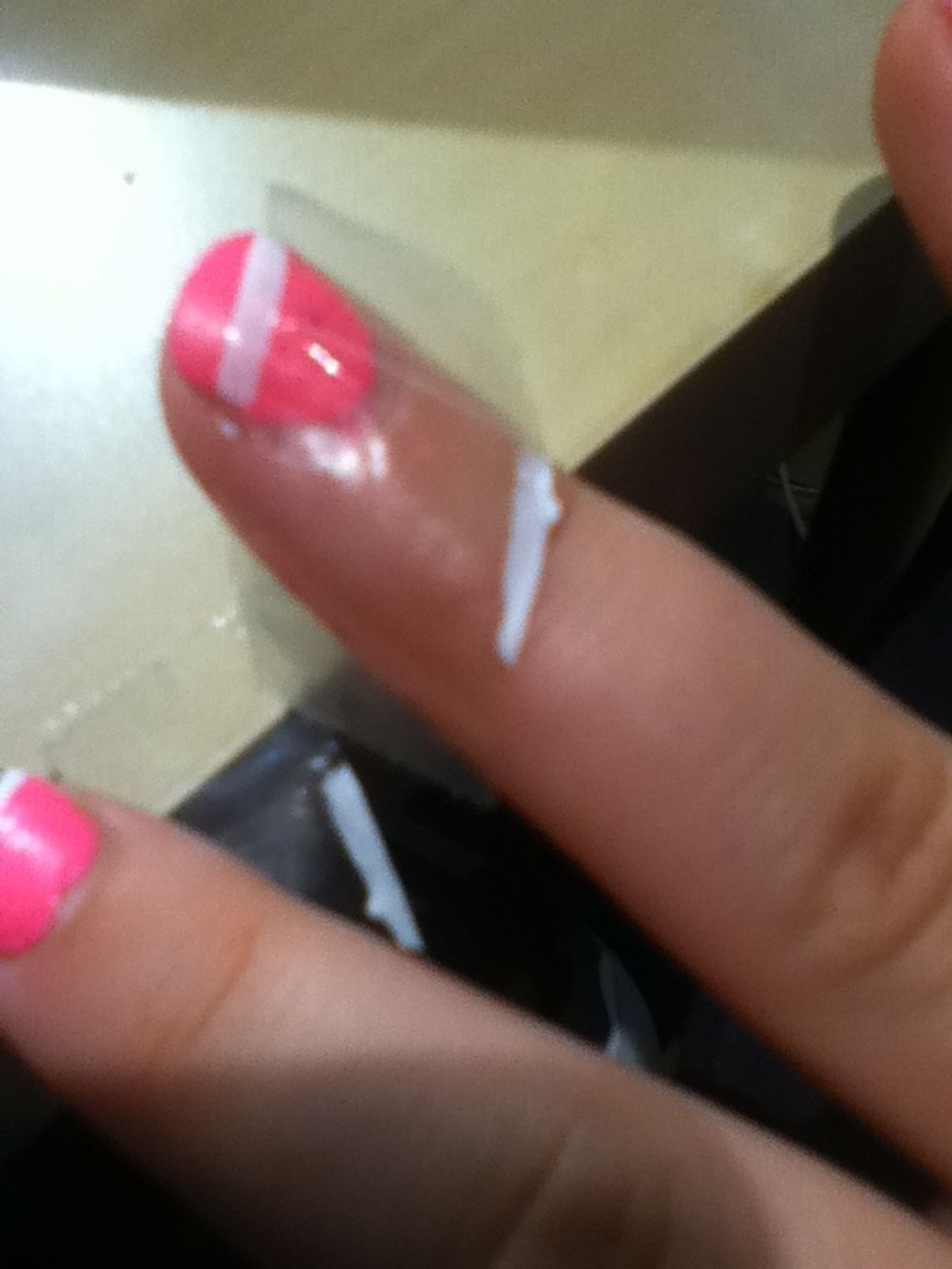 When the white is dry put your tape back onto the nail so that a little bit of the white is sticking out from the tape and try to line the tape up at a similar angle ( just follow the polish really)