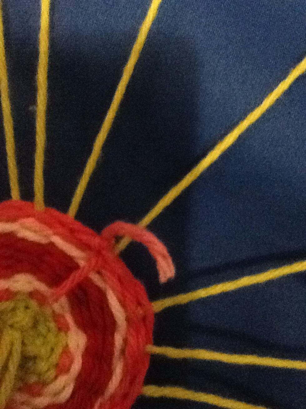 When the yarn runs out, tie the next piece to the end and continue. As you go around the loom, make sure your knot stays behind your weaving.