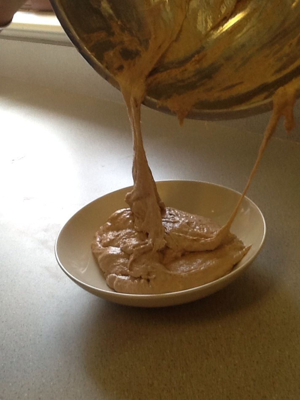 When the yeast and flour are both mixed well together. Put the dough in a custard cup.