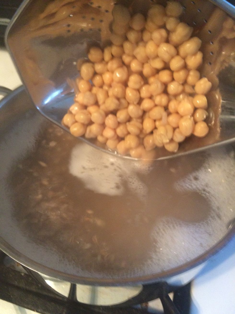 When there is 4 minutes left on the farro, add the drained chickpeas to the pot.